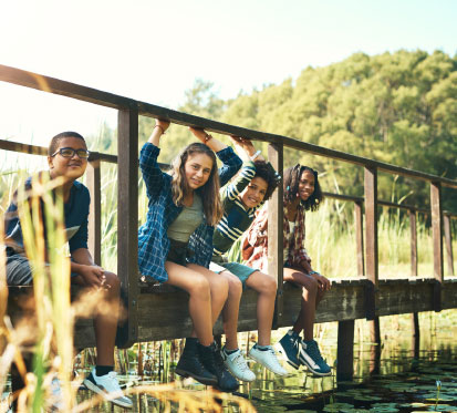 Teanagers sitting on a footbridge