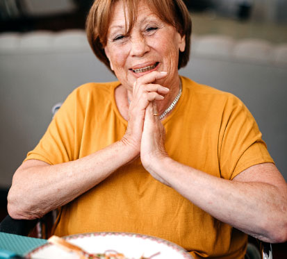 Elderly woman having a meal