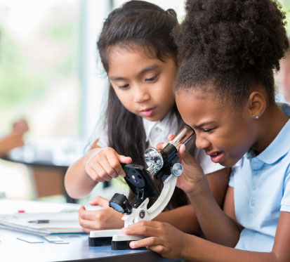 Children using microscope
