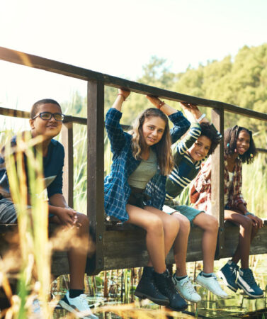 Teanagers sitting on a footbridge