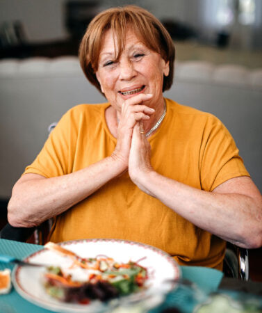 Elderly woman having a meal