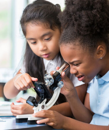 Children using microscope